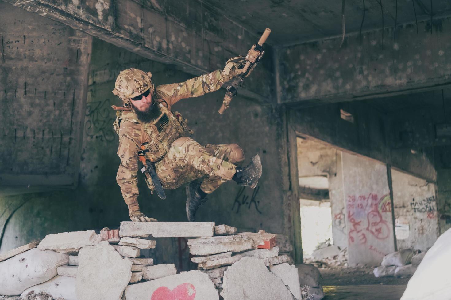 A bearded soldier in uniform of special forces in a dangerous military action in a dangerous enemy area. Selective focus photo