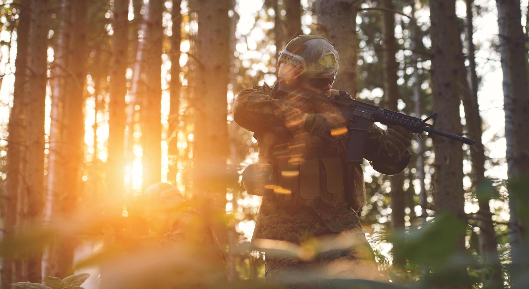 soldier in action aiming  on weapon  laser sight optics photo