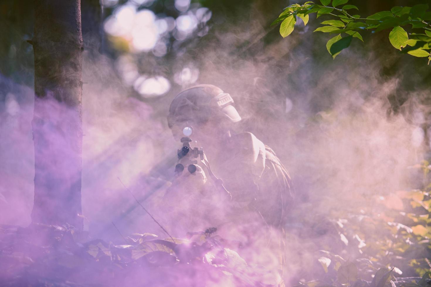 soldier in action aiming  on weapon  laser sight optics photo