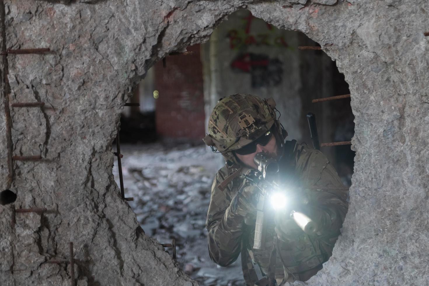 A bearded soldier in uniform of special forces in a dangerous military action in a dangerous enemy area. Selective focus photo