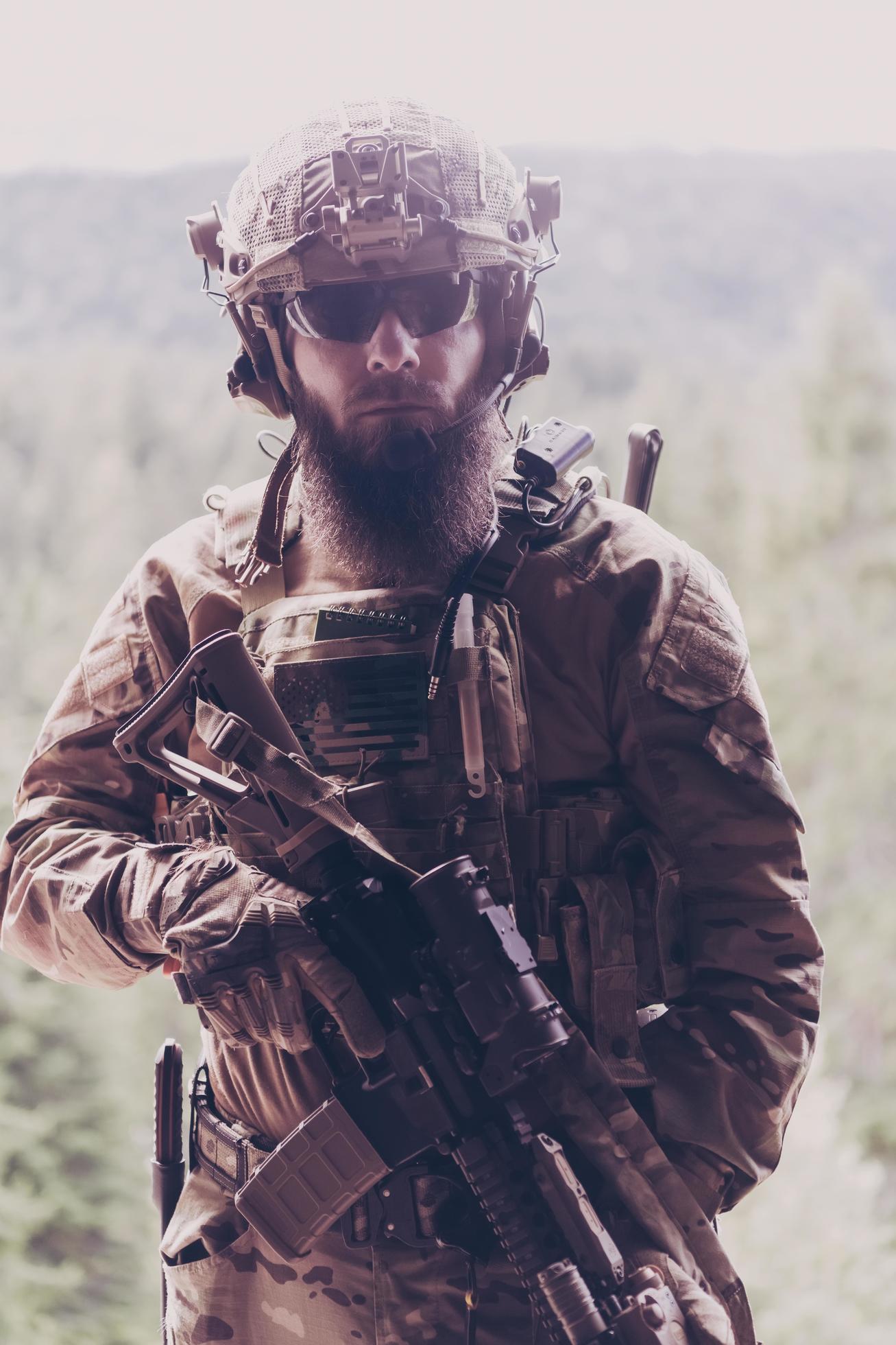 War concept. A bearded soldier in a special forces uniform fighting an  enemy in a forest area. Selective focus 11868648 Stock Photo at Vecteezy