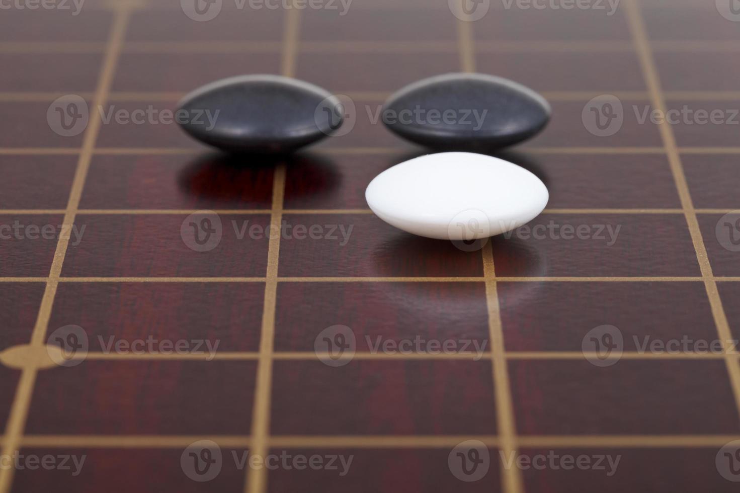 three stones during go game playing on goban photo