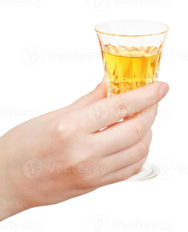 hand holds glass of dessert wine isolated photo