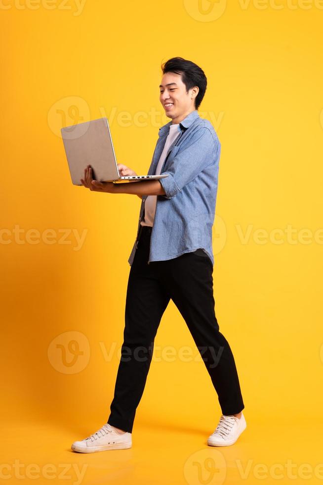 full body image of asian man posing on yellow background photo