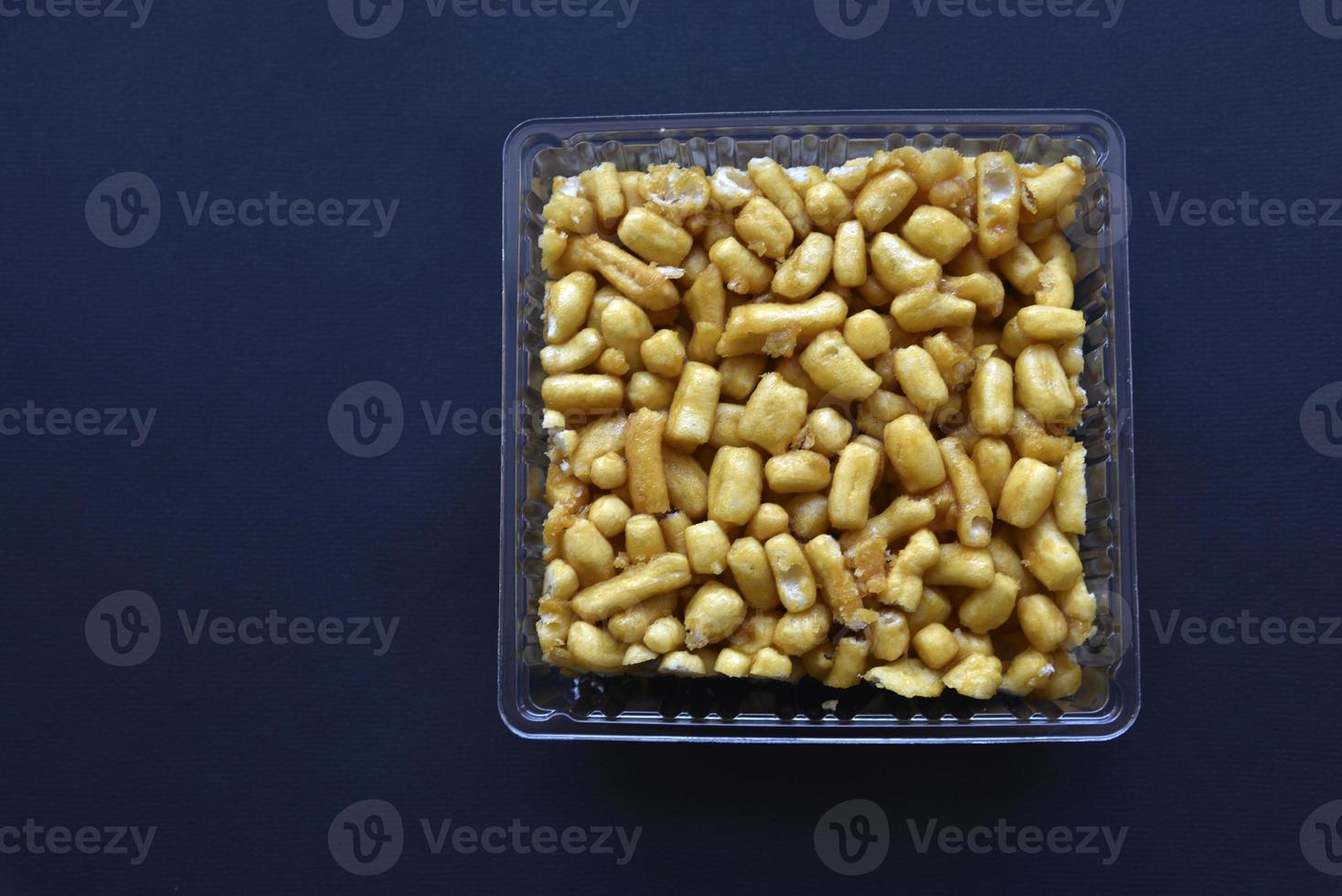 Sweet snack chuck-chuck in a package on a black background. Honey snack made of dough. photo