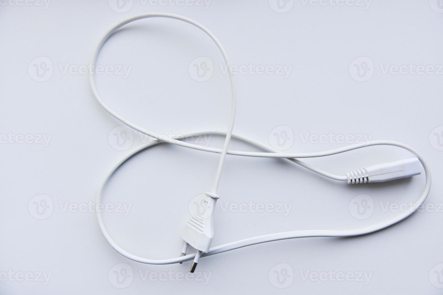 White power cord on a white background. Electric cord on a white background. photo