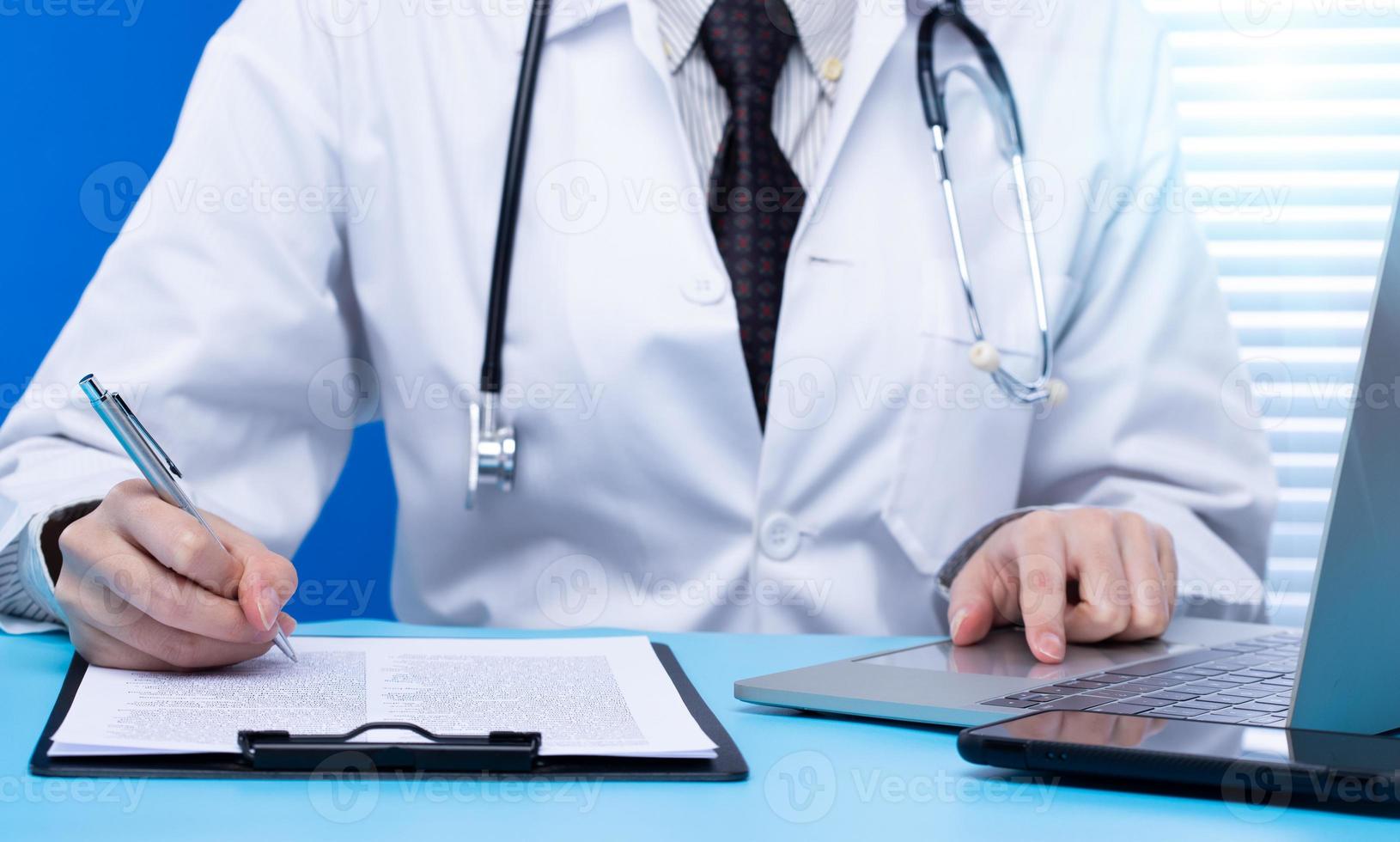 Professional Doctor sign Health care medical document of patient medicine in hospital office. Doctor wear lab coat uniform read patient chart on desk for insurance person and note pen, copy space photo