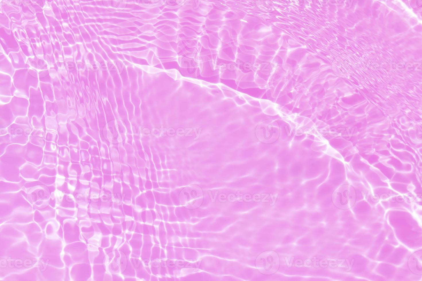 Defocus blurred transparent purple colored clear calm water surface texture with splash, bubble. Shining purple water ripple background. Surface of water in swimming pool. Tropical purple water color. photo