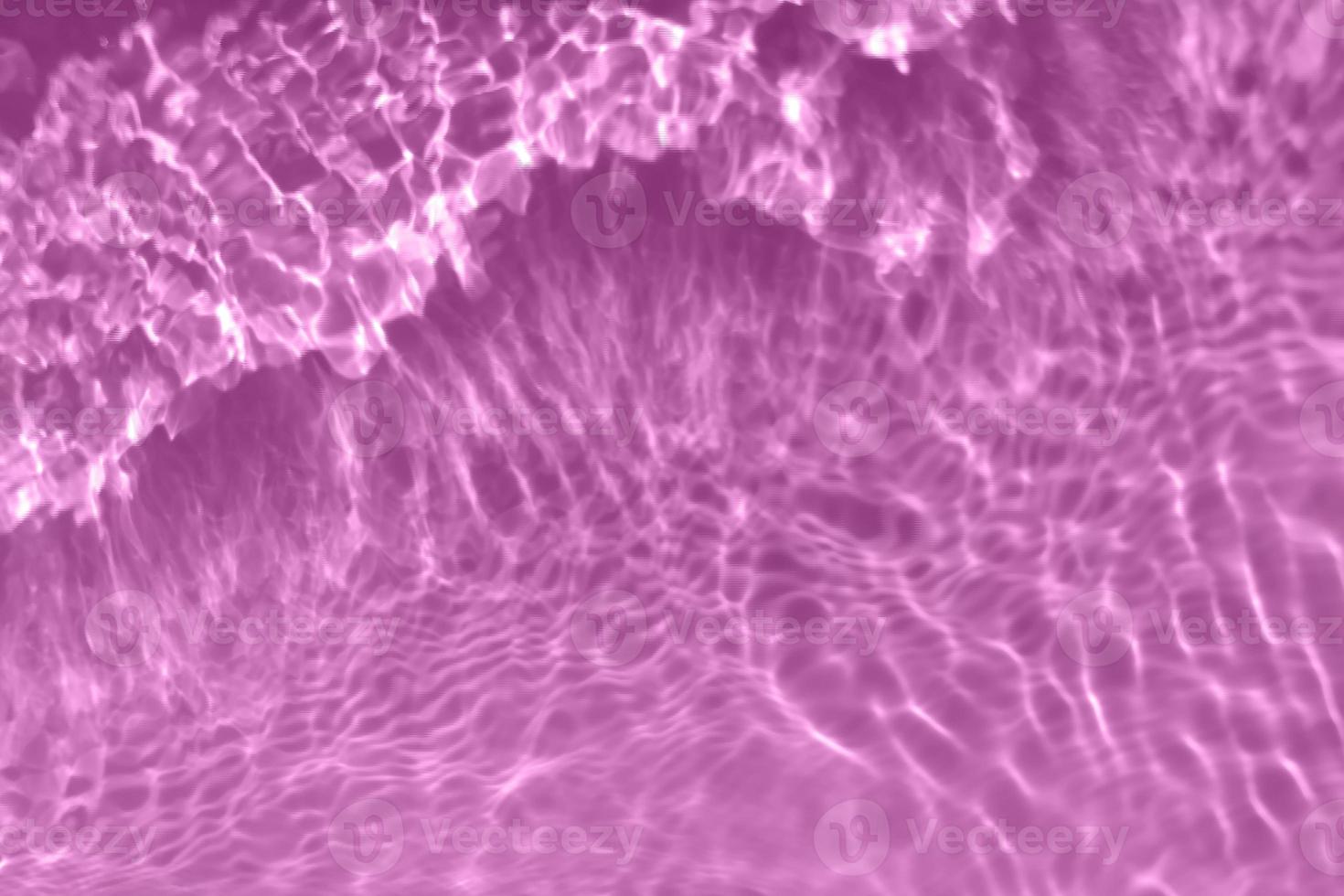 Defocus blurred transparent purple colored clear calm water surface texture with splash, bubble. Shining purple water ripple background. Surface of water in swimming pool. Tropical purple water color. photo