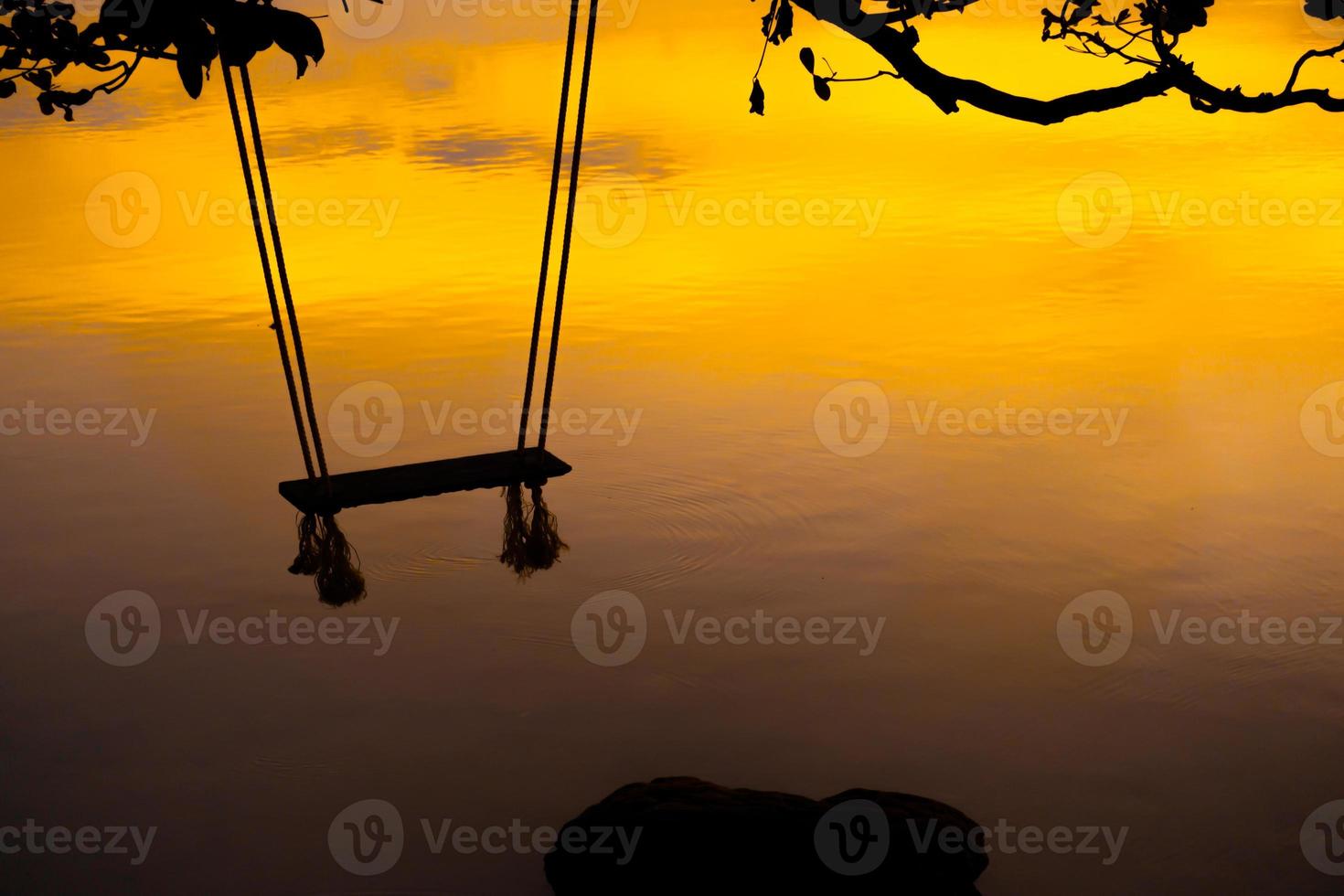 Wood swing beautiful sunset on the sea pink background photo