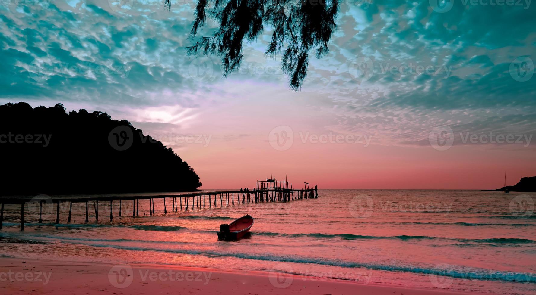 Seascape in the sunset with a small boat against dark blue sky and cloudy sky for travel in holiday relax time as summer photo