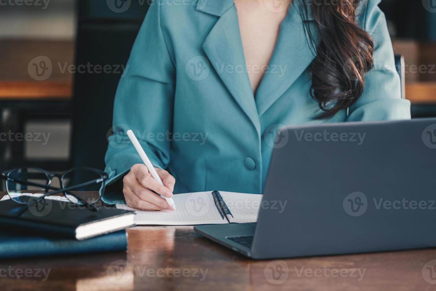 Investment concepts, businesswomen use document and computers to analyze stock markets, quantitative data collection, financial statement analysis, profitability through internet technology. photo