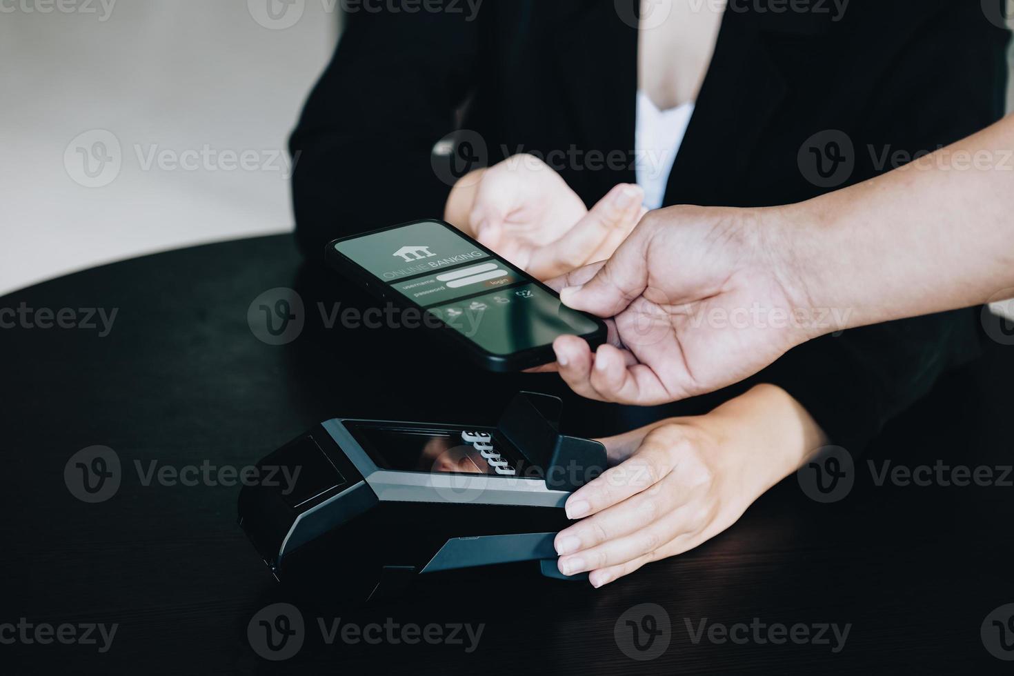 Payment security technology concept and service fees, Employees are holding electronic card machines for customers to use smartphone mobile to pay via paywave technology. photo