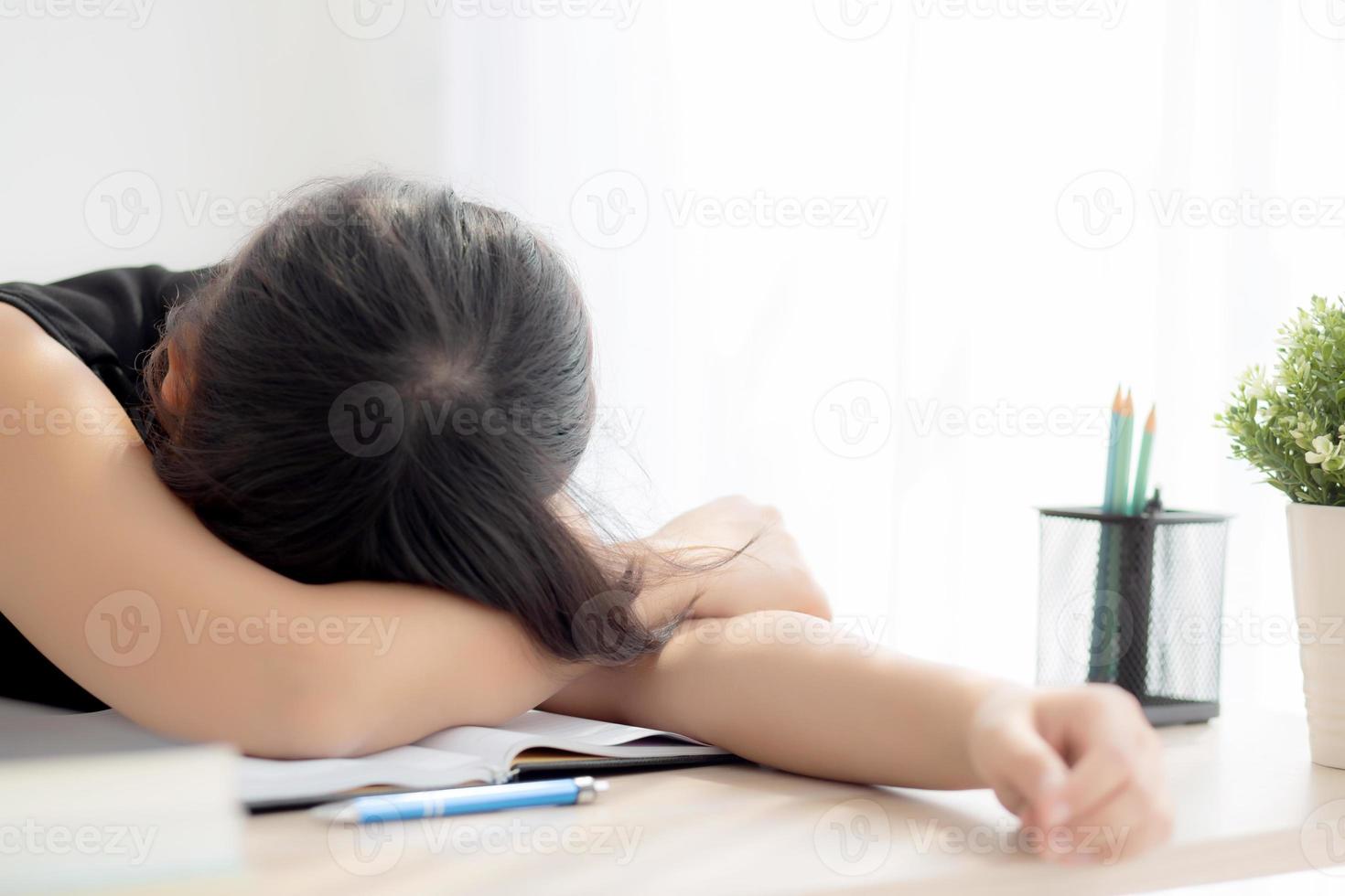 Beautiful portrait young asian woman learning exam or homework and sleep with tired and stress, lifestyle beauty asia girl having fatigue with work, education and business concept. photo