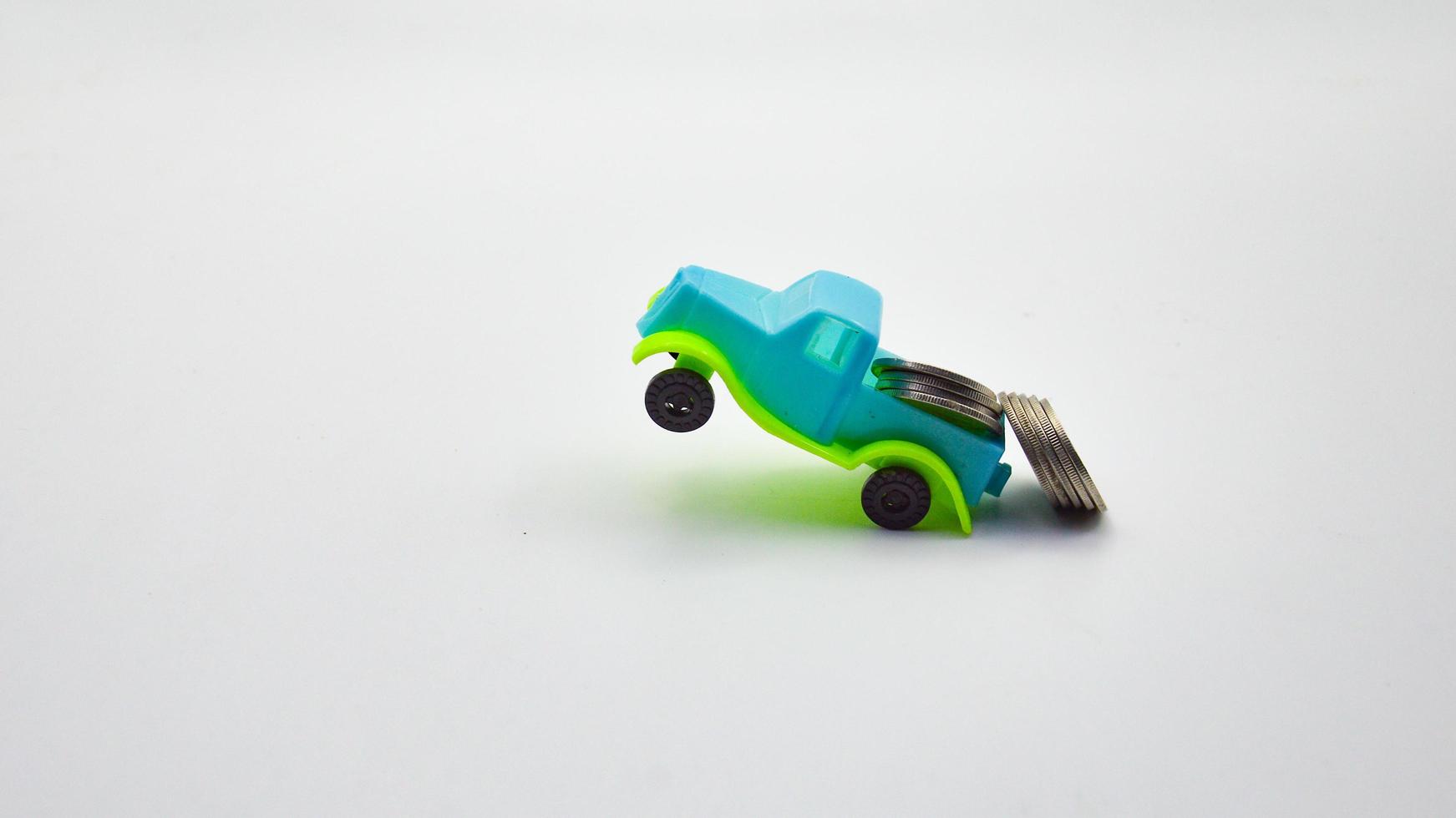 Silver coins stacked on a blue-green truck.  white background concept car insurance policy financial business photo