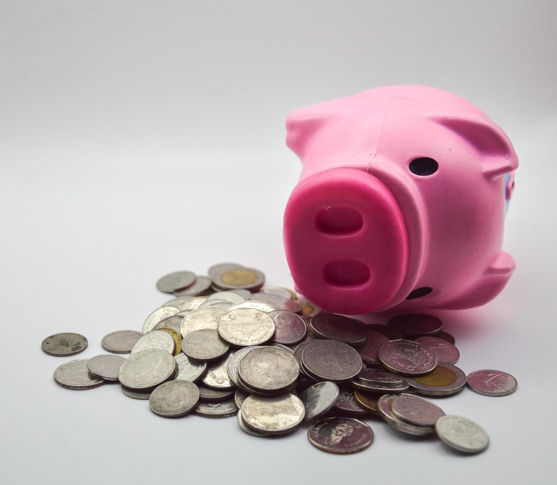 pink pig lying on a pile of coins  white background concept savings bank account bank account finance economy retirement photo
