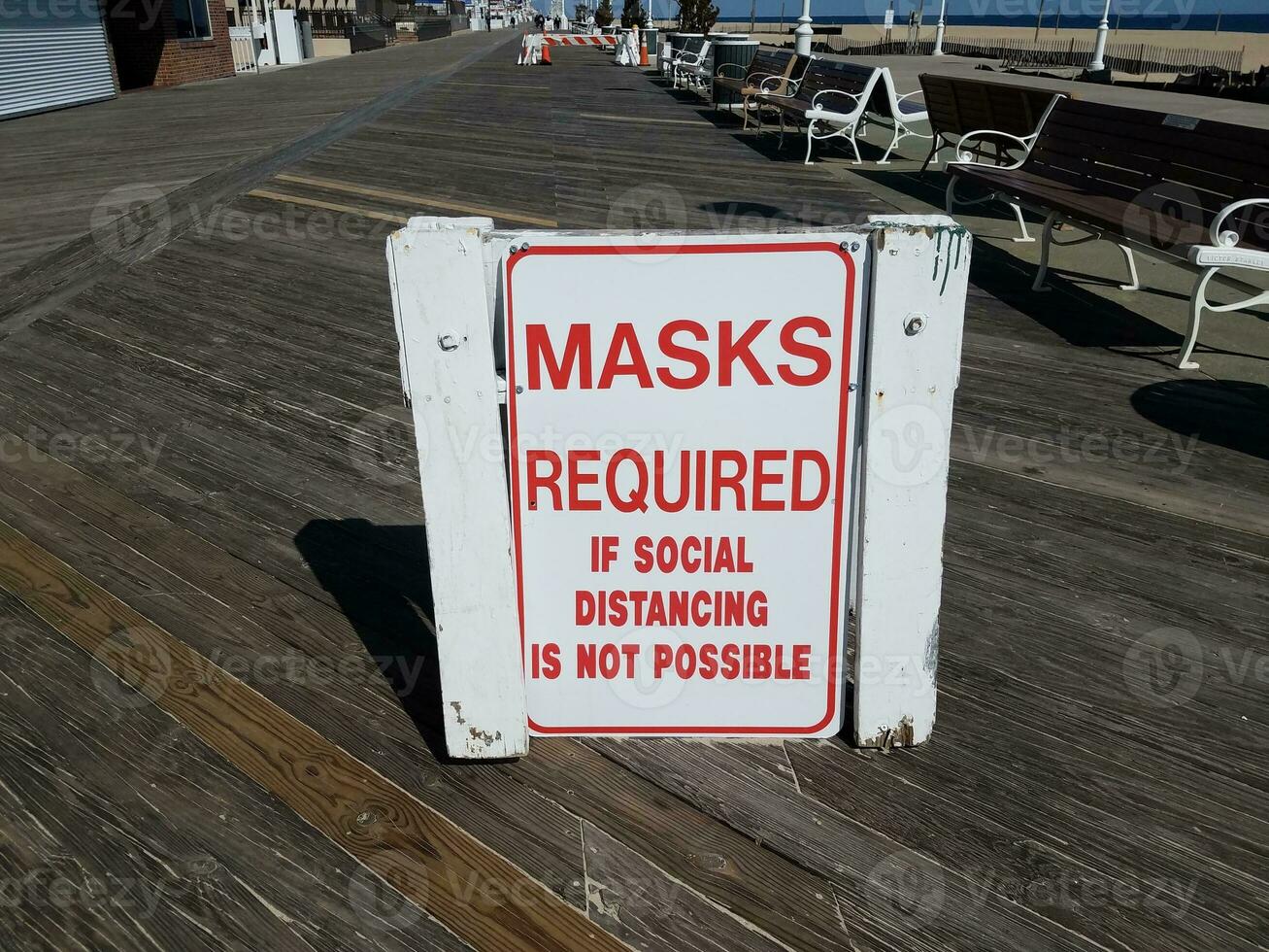 masks required if social distancing is not possible sign on boardwalk photo