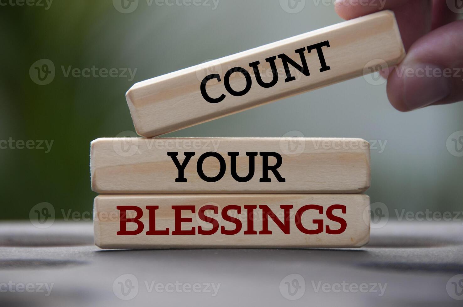 Count your blessings text on wooden blocks with blurred park background. Blessing concept photo