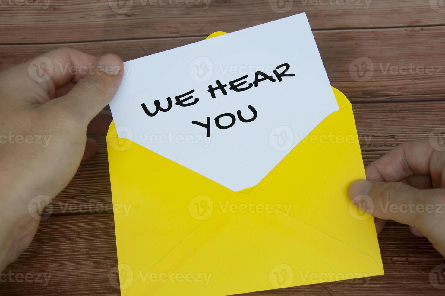 We hear you text on white notepad in yellow envelope. Listening concept photo