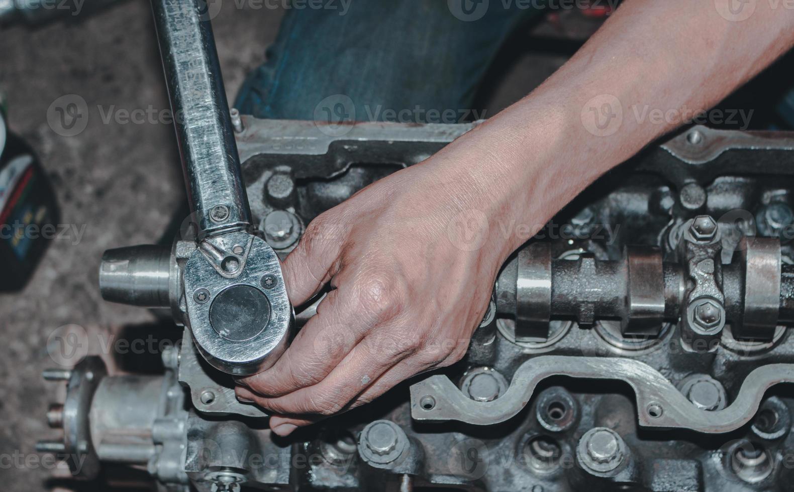 The mechanic is checking the engine. photo
