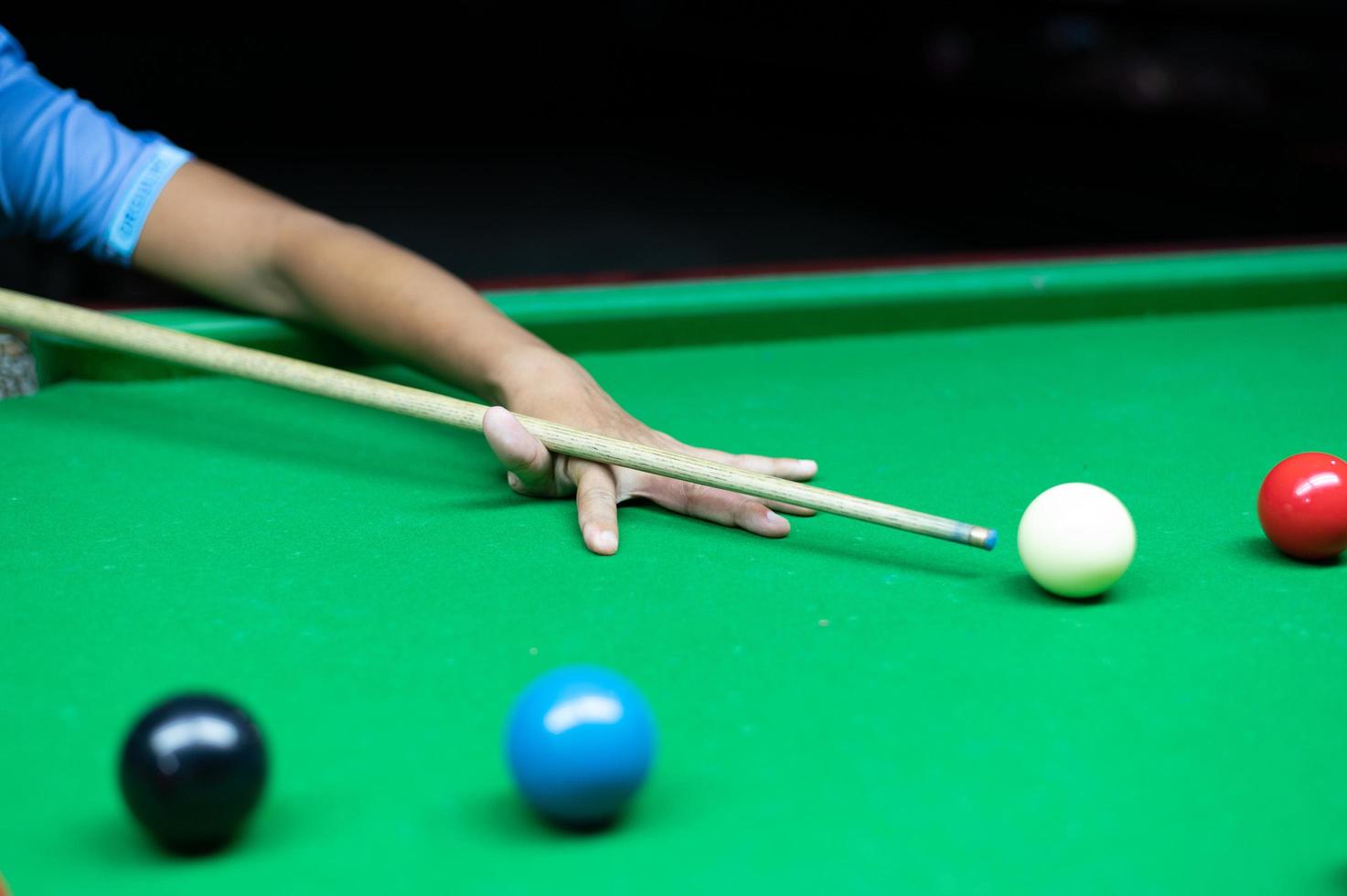 An Asian woman playing snooker. photo