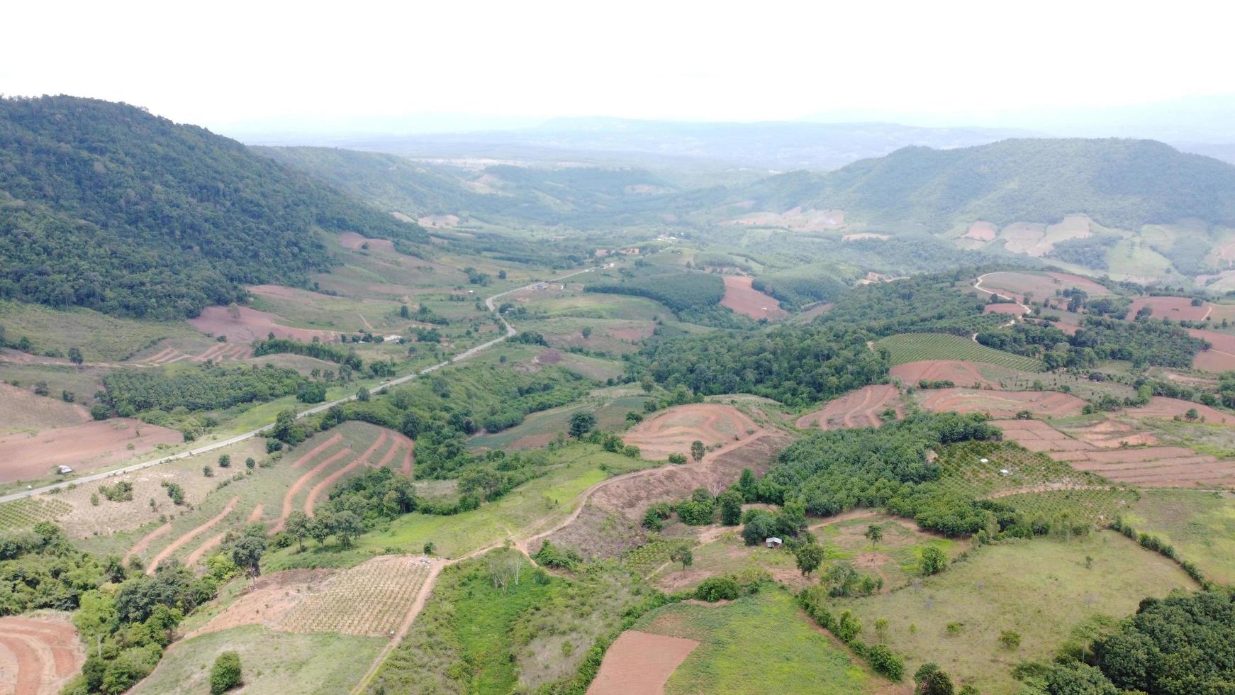 Beautiful aerial view to road with moutains and forest captured from above, photo