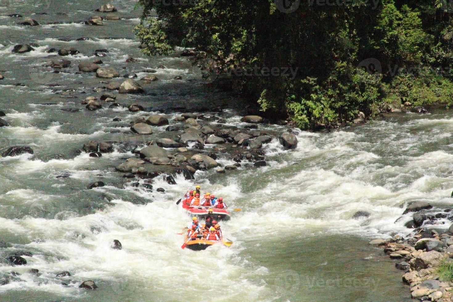 Photo of rafting activities carried out by a group of people on a rocky river with strong currents