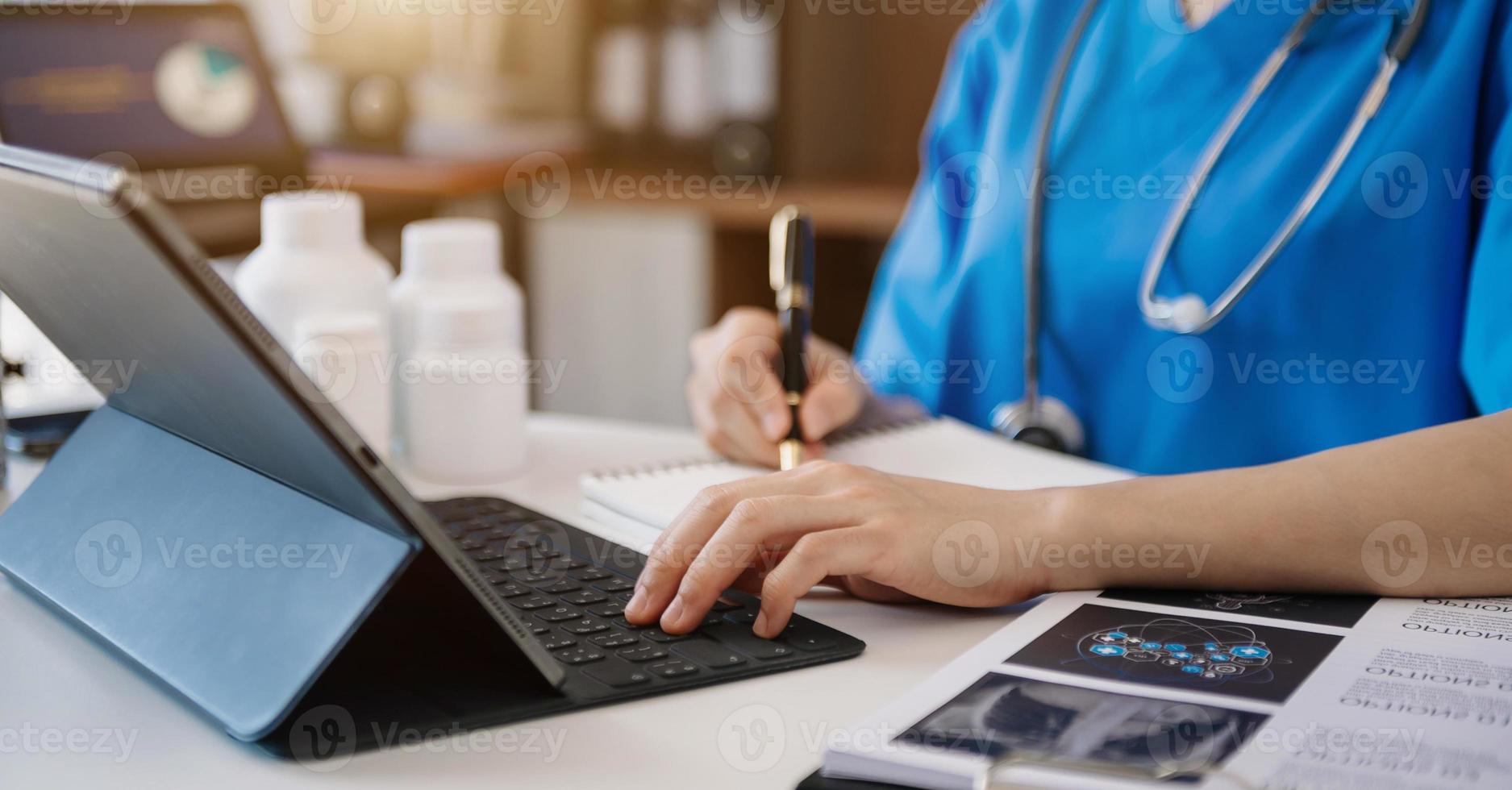 Medical technology concept. Doctor working with tablet keyboard mobile phone and stethoscope photo