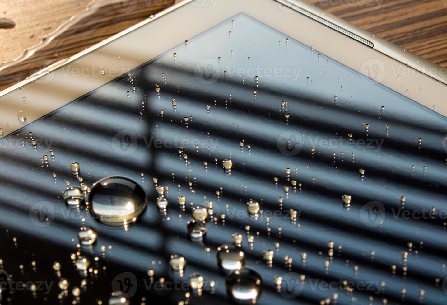 Water spilled onto the tablet, Drops of water on tablet screen photo