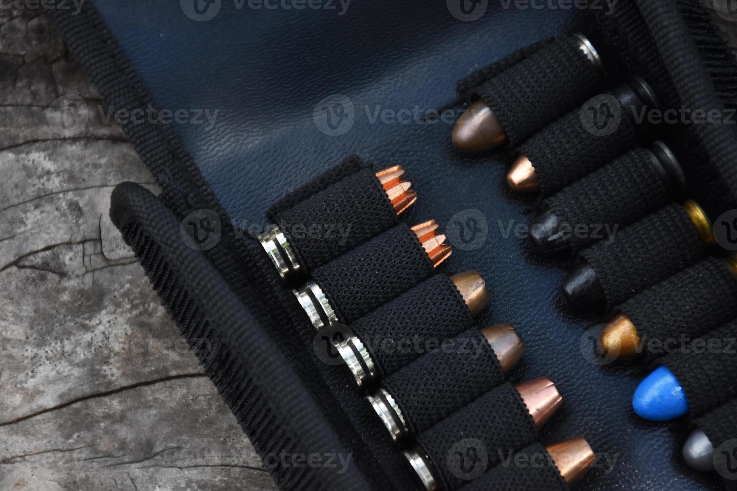 9mm pistol bullets kept in black leather pocket, selective focus on