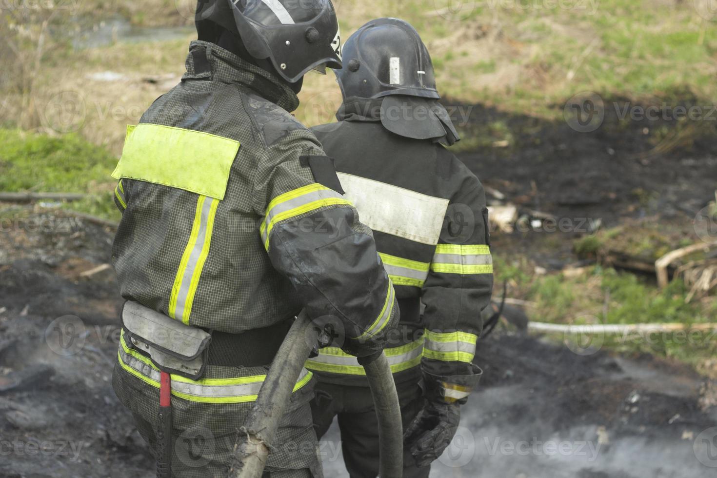 Lifeguard on duty. Firefighter puts out fire. Details of fire. Rescuer in Russia. photo