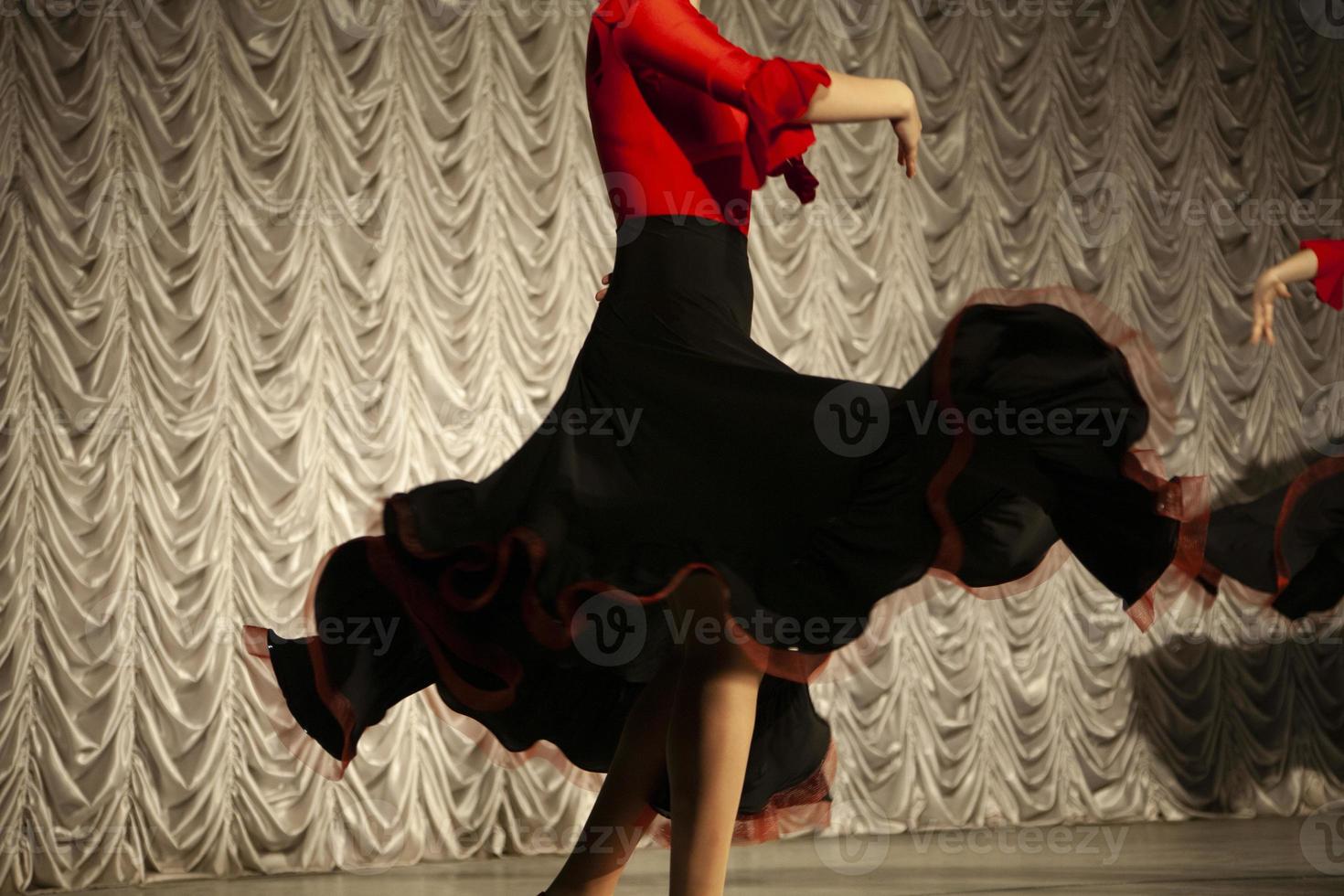 Spanish dance. Black dress. Dancer on stage. Details of speech. Incendiary movement. photo