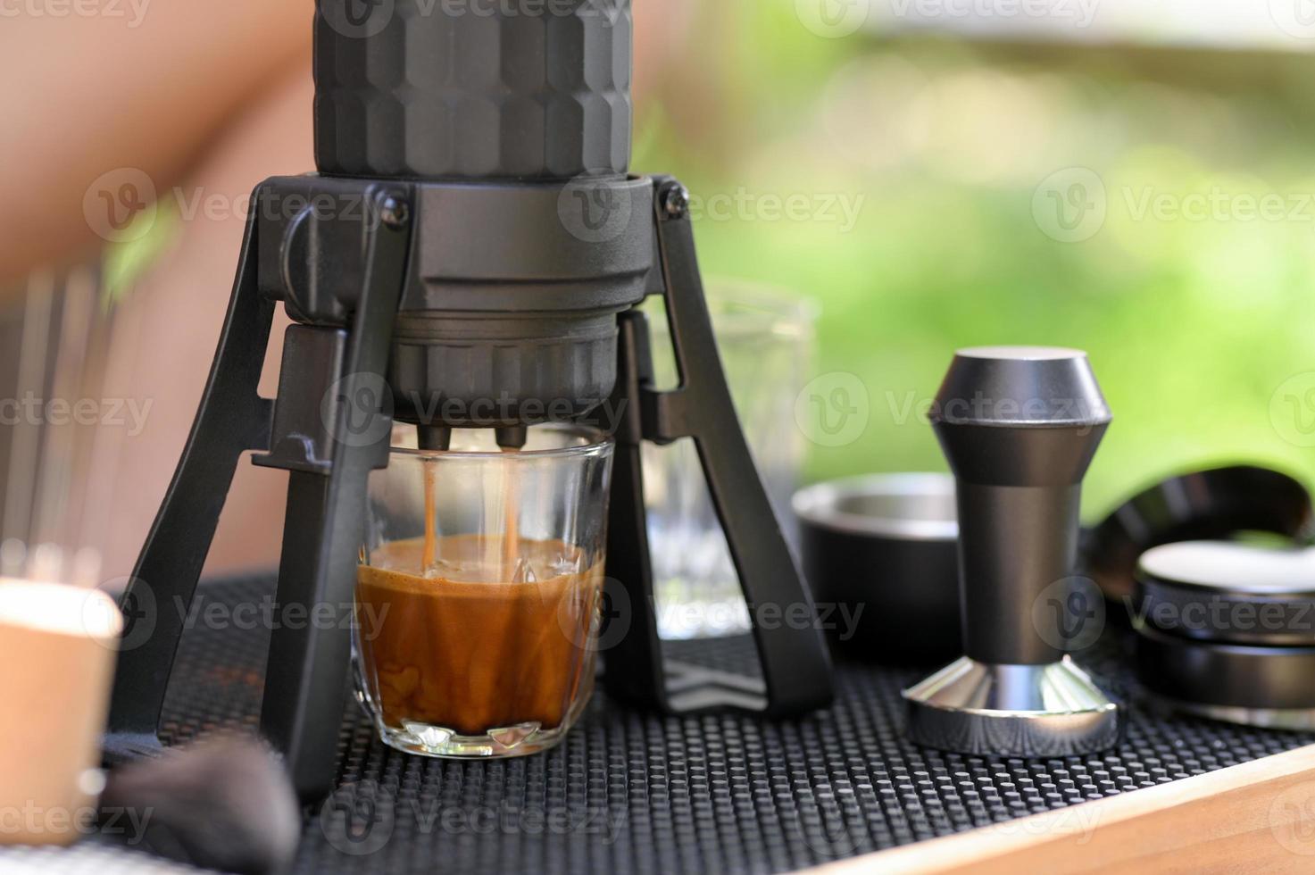 Close-up of hand Barista cafe making coffee with manual presses ground  coffee using a tamper at the coffee shop 27393656 Stock Photo at Vecteezy