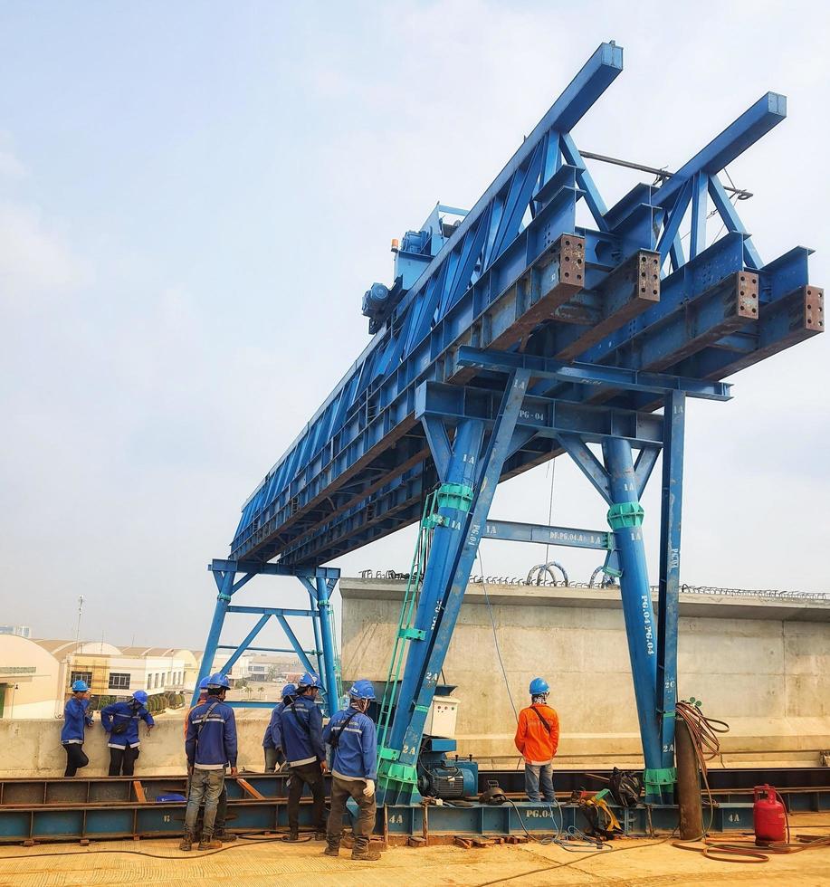 Jakarta, Indonesia on August 2022. A team is preparing to launch a precast girder on a trolley as one of the work cycles in erection girder work. photo