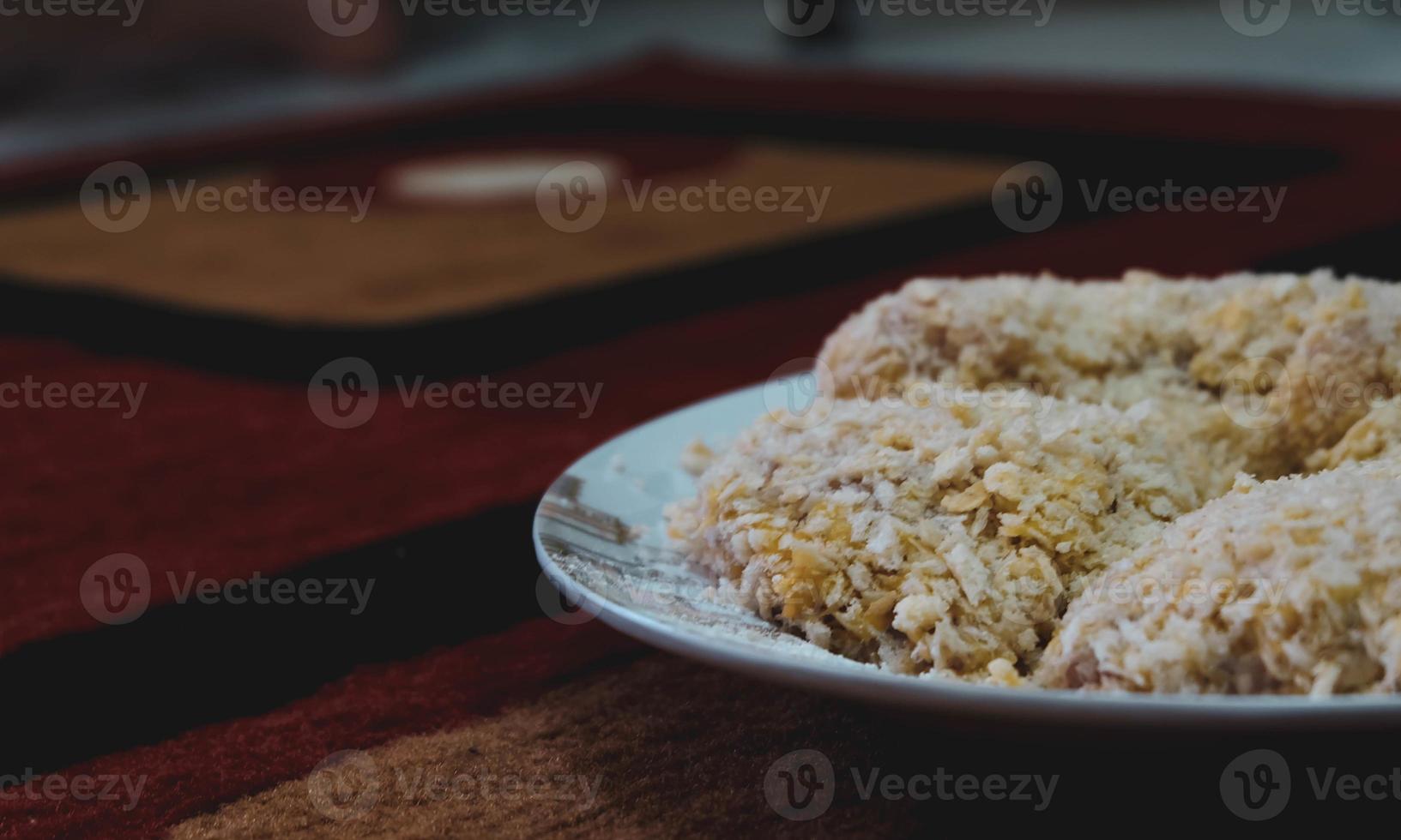 Chicken coated with breadcrumbs is ready to be fried,. photo