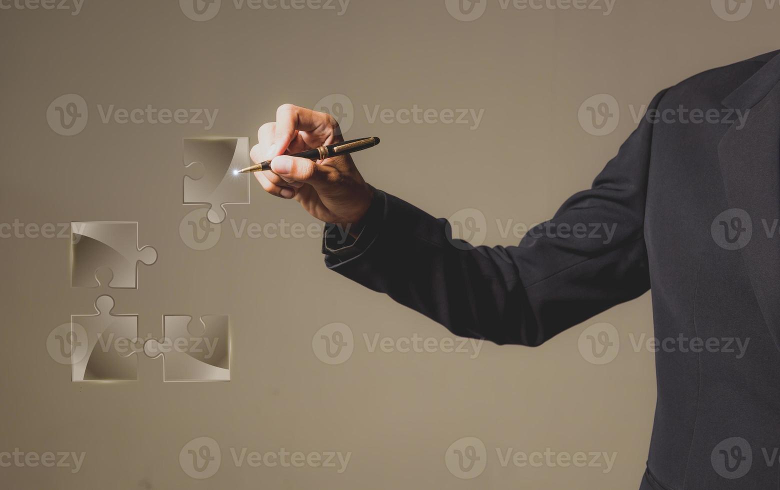 Businessman with jigsaw puzzle on transparent display - solution or network concept. photo