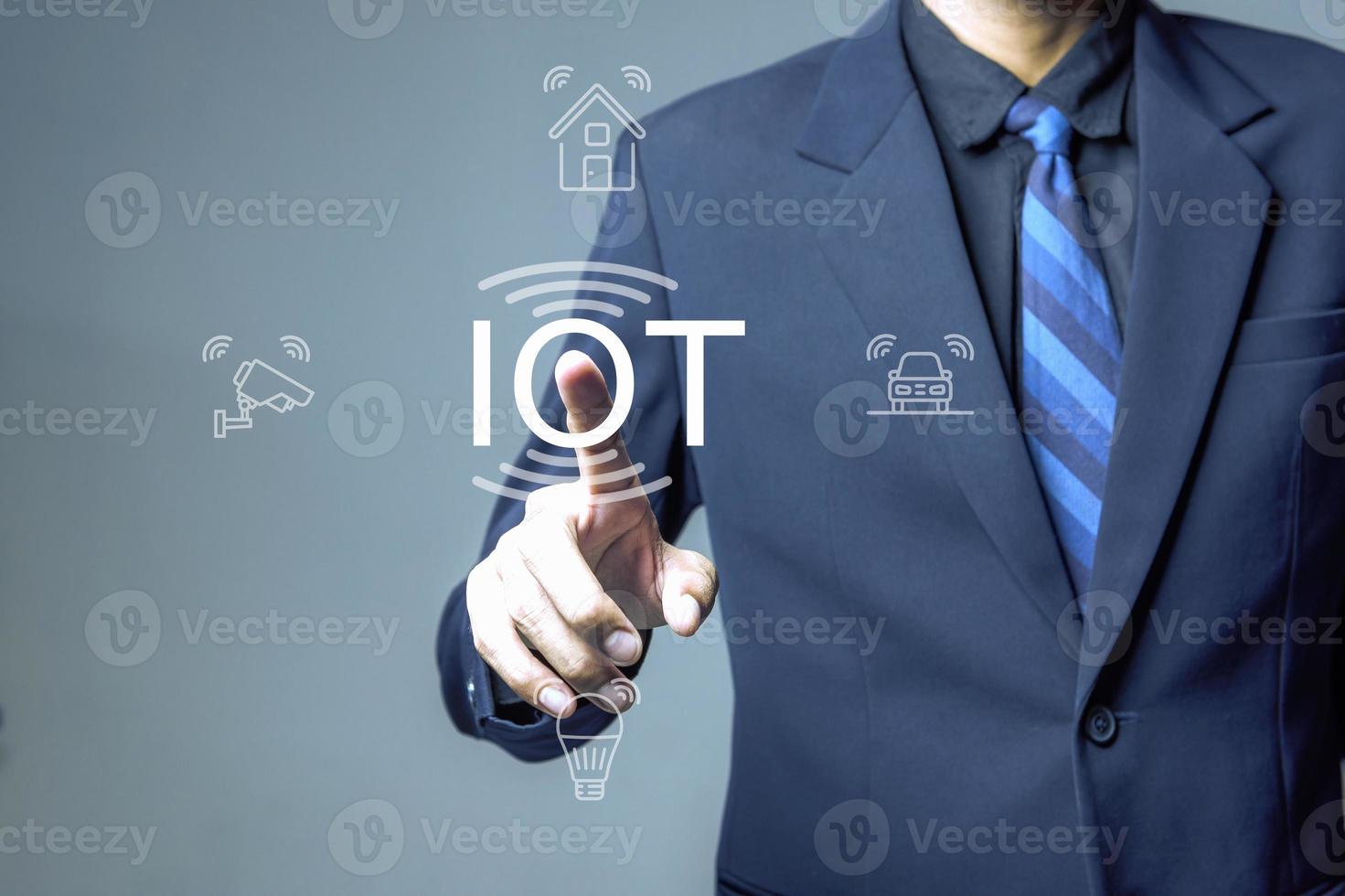 Businessman pushing IoT solutions photo