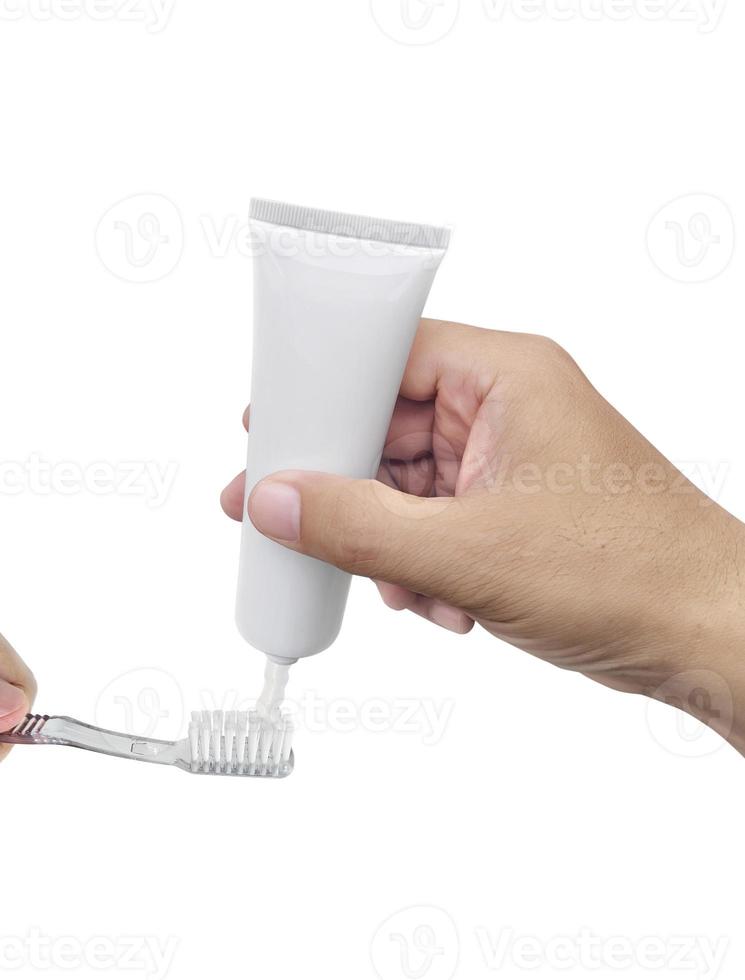 The guy squeezes toothpaste on the toothbrush photo