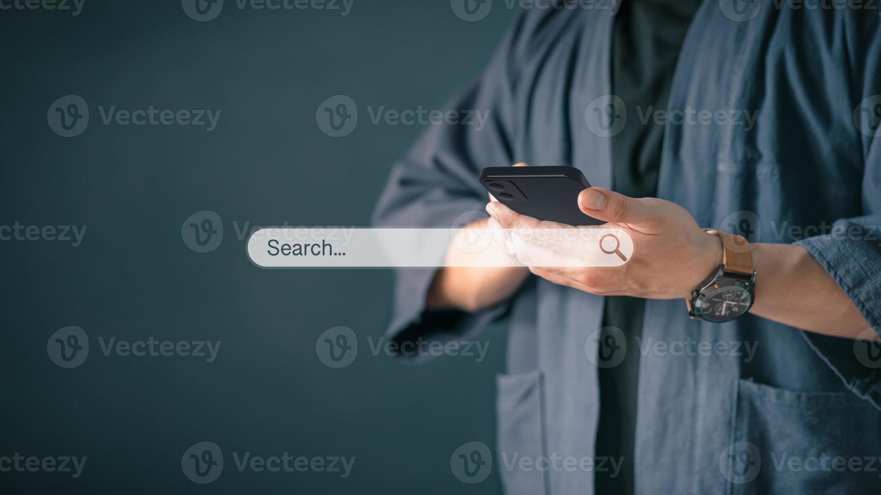 Man using a mobile phone in the room for searching browsing internet data information. Business concept for Using search with your website. photo