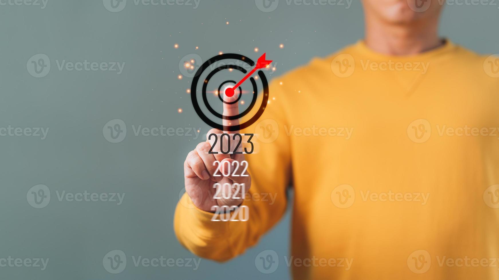 Finger pressing start goal 2023 on virtual interface with copy space for text. New year resolutions planning concept. photo