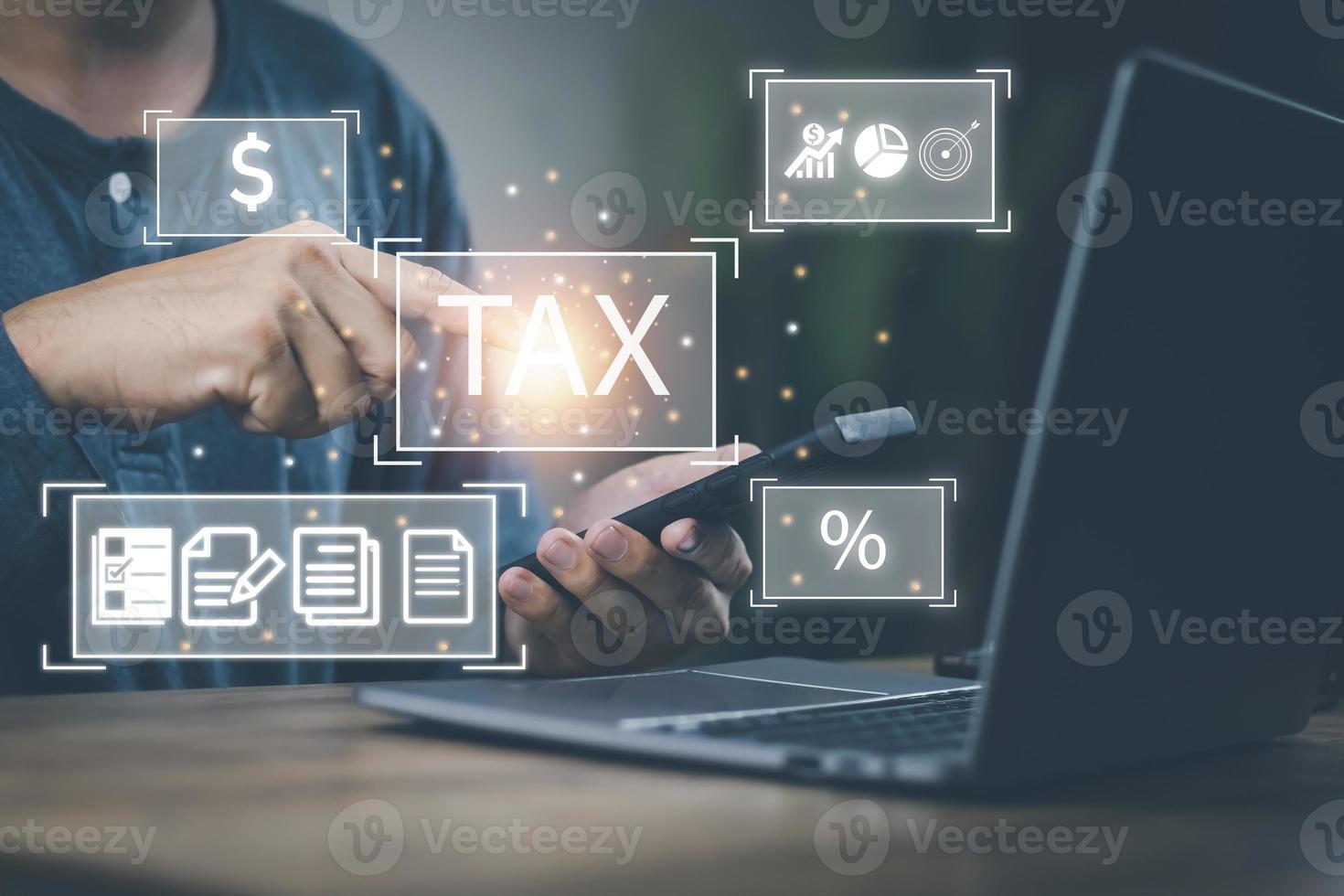 Financial tax return concept, a man's hand using a smartphone and a computer to work in accounting and tax photo