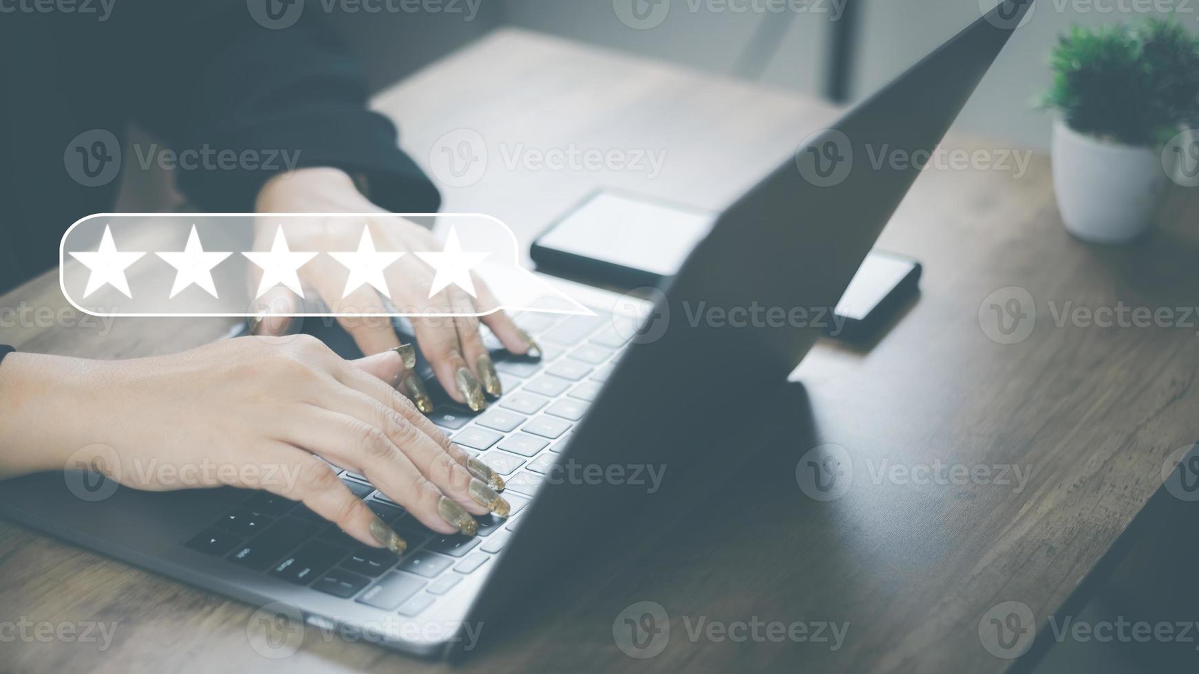Customer Satisfaction Survey Concept, A woman's hand using a smartphone gives a 5 star rating to show the highest level of satisfaction with excellent service.. photo