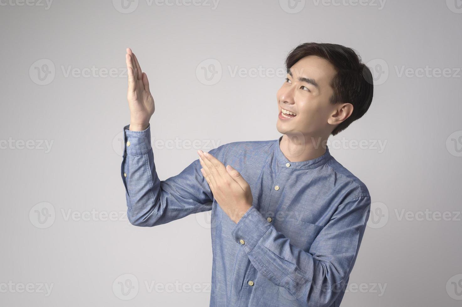 Portrait of young asian man over white background studio. photo