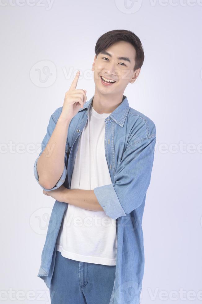 Portrait of young asian man over white background studio. photo