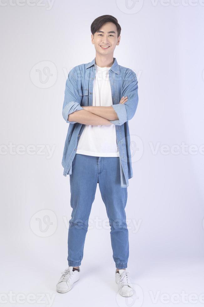 Portrait of young asian man over white background studio. photo