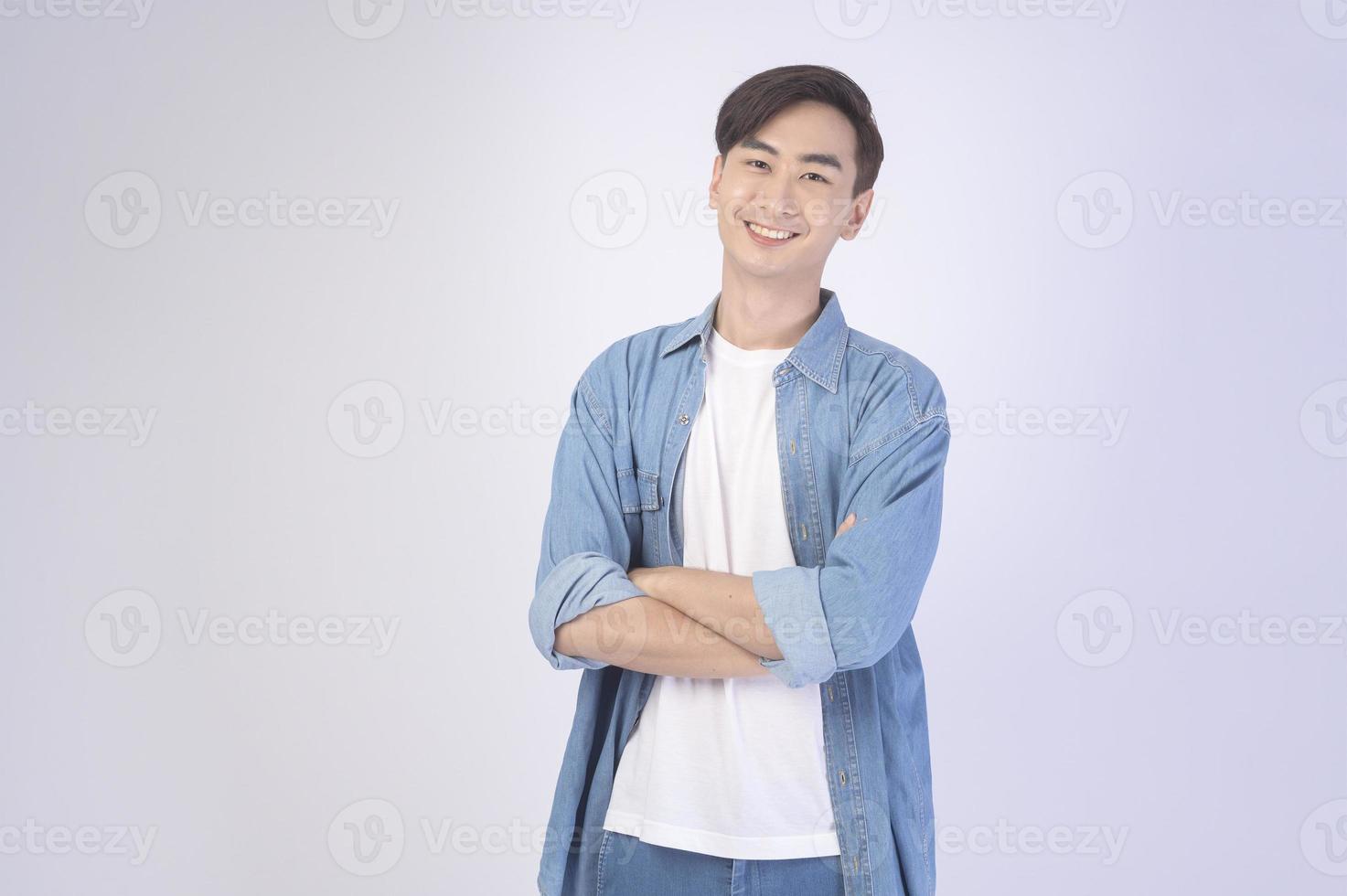 Portrait of young asian man over white background studio. photo