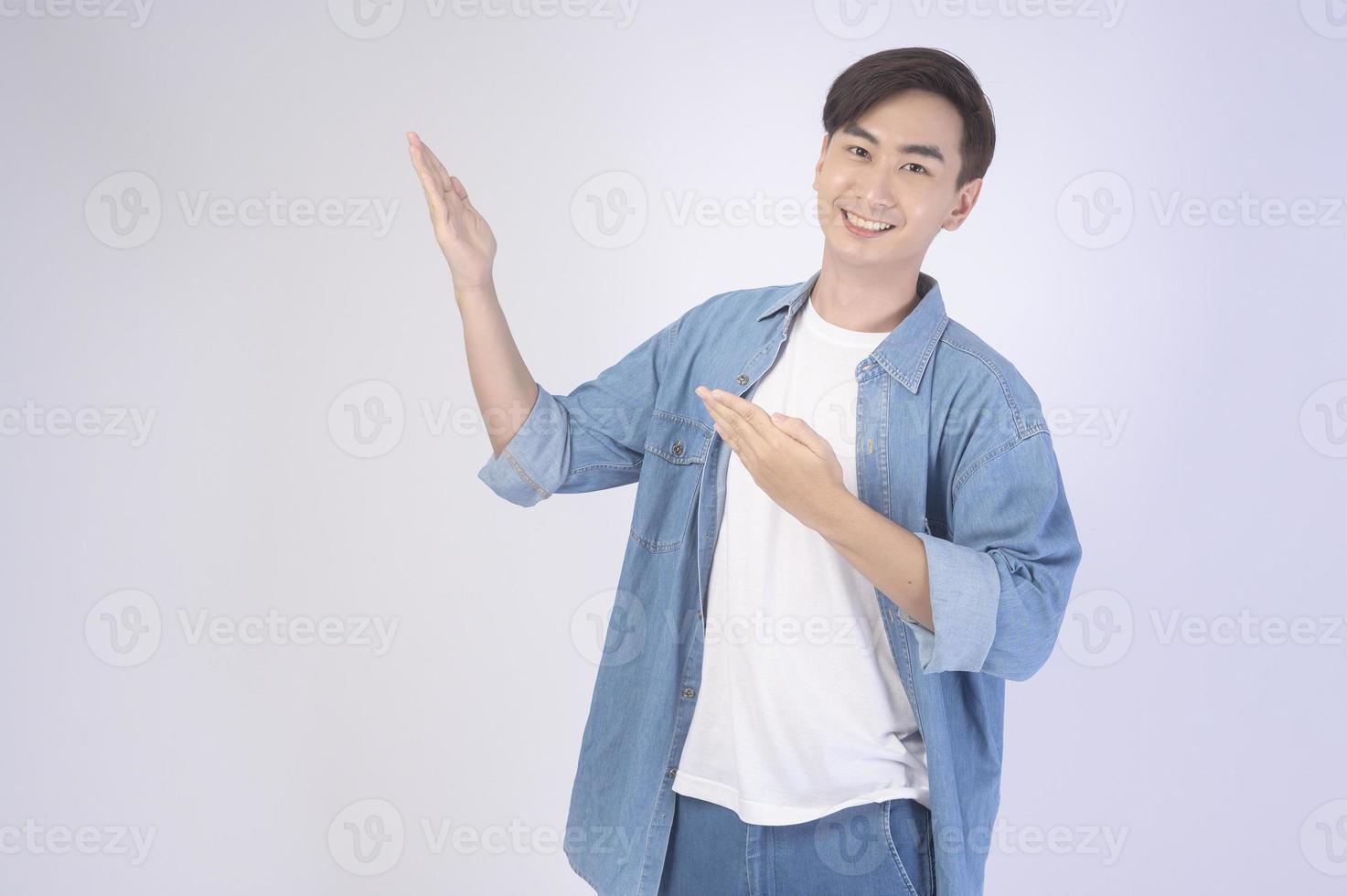 Portrait of young asian man over white background studio. photo