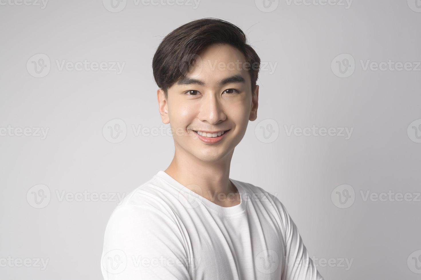 Portrait of young asian man over white background studio. photo