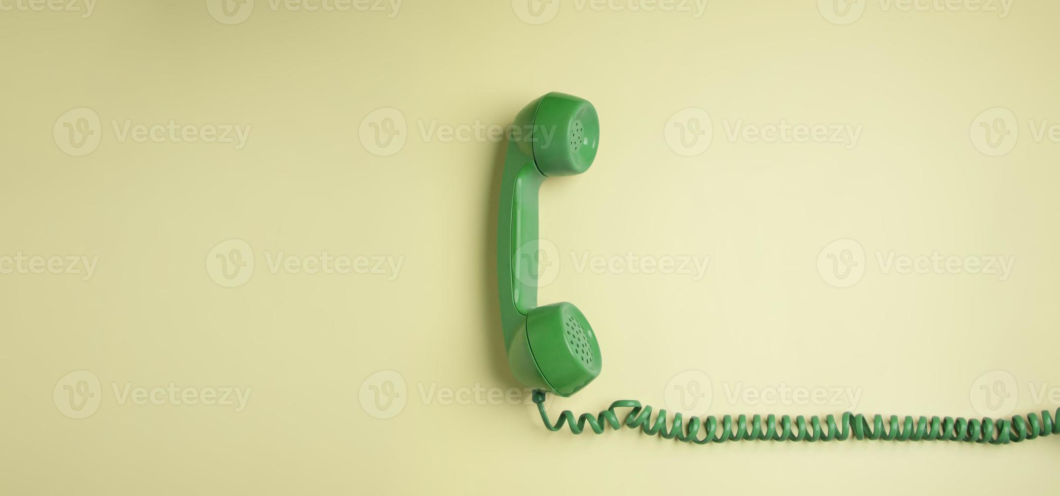 Green Vintage Retro Telephone Handset Hanfing on Pink background. Old Object from 1980-1990, Technology and Communication in the Past. Clean, Colourful  and Minimal photo