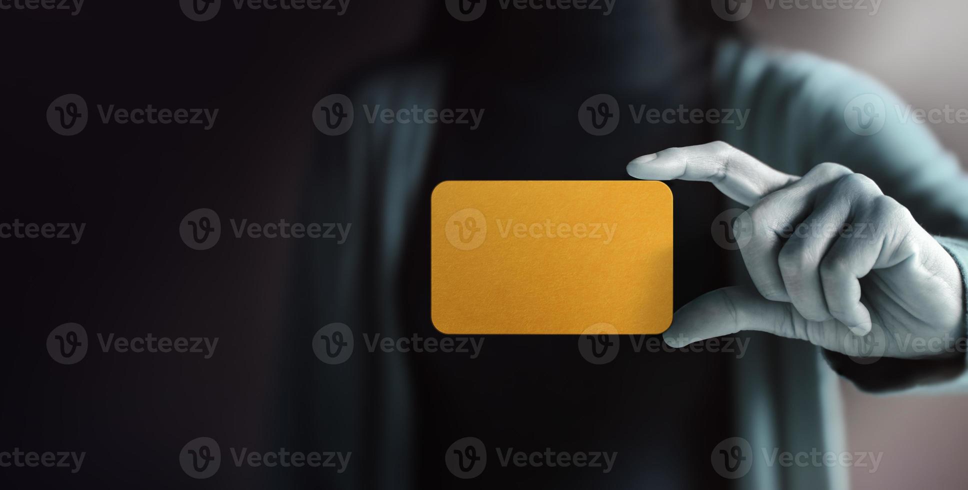 Business Card Mockup Image. Woman Holding a Blank Gold Card. Raised into the Camera. Selective focus. Front View photo